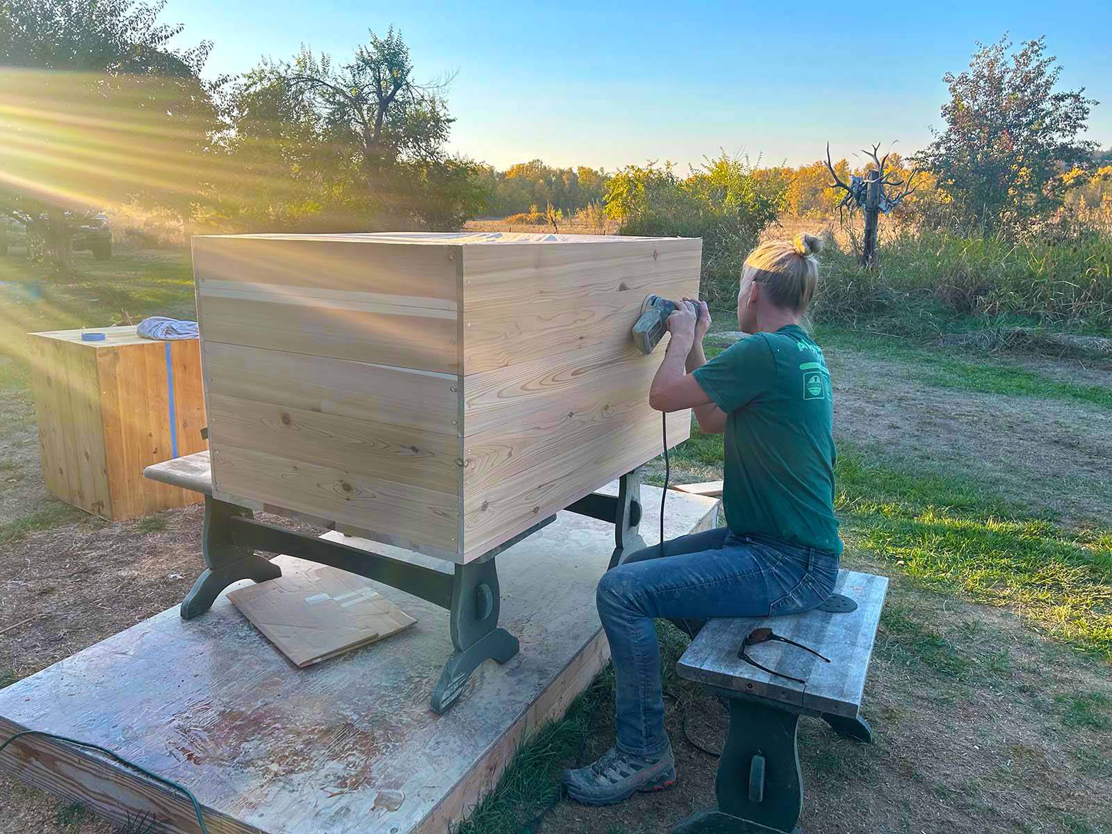 Hand sanding wood tub in Oregon workshop