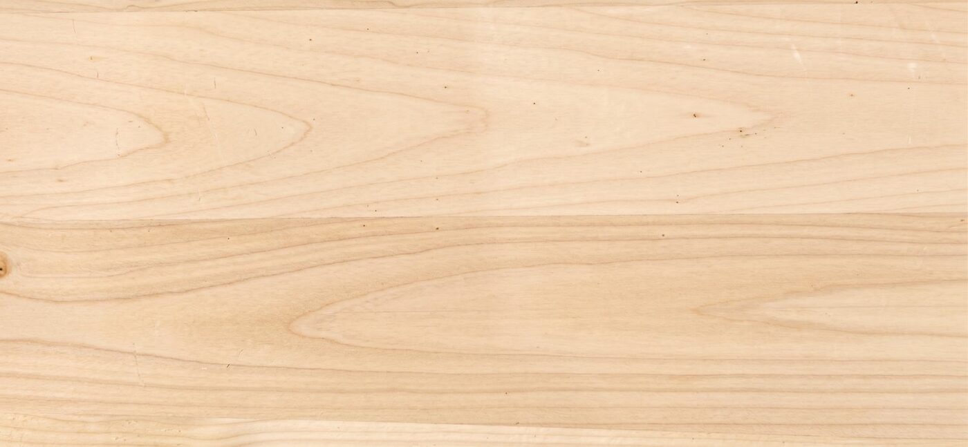 Raw Port Orford cedar board in clear mixed grain, showing arched cathedral figure in a pale straw color