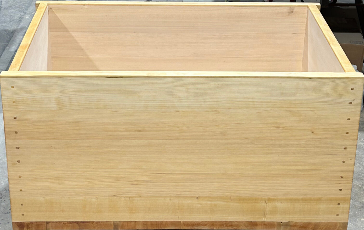 Finished Port Orford cedar tub in clear vertical grain, showing straight parallel grain lines in a pale straw color